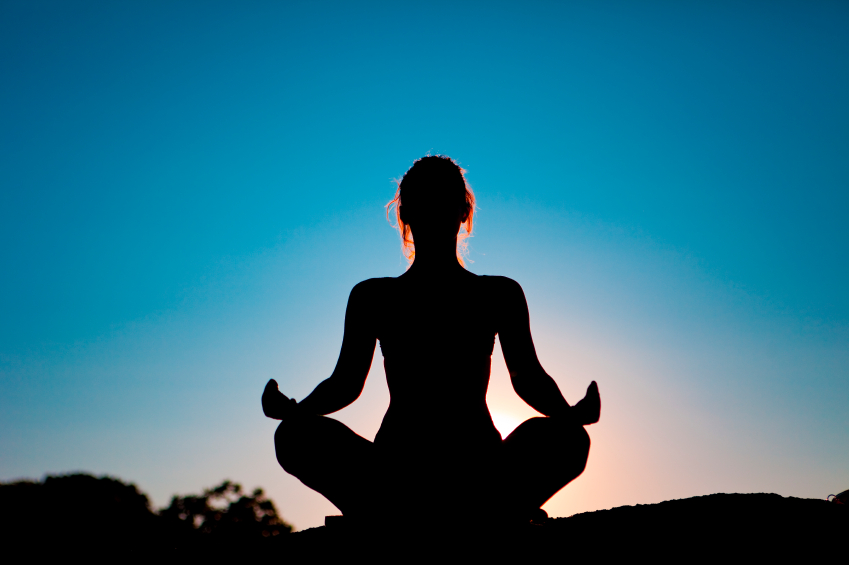 Silhouette image of woman meditating