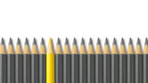 yellow pencil standing out from crowd of gray pencils