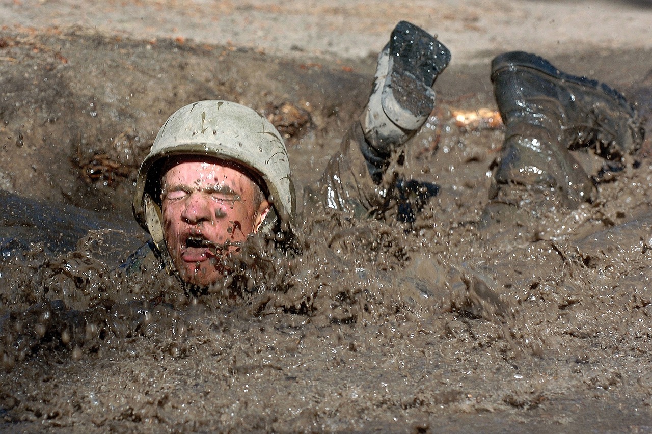 Seek Stress to Learn - Soldier crawling through deep mud