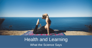 Health and Learning - Woman doing yoga on mat in front of ocean
